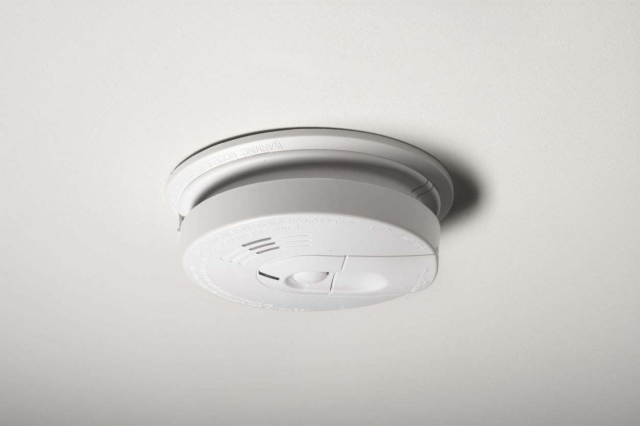 A smoke detector on the ceiling of a home
