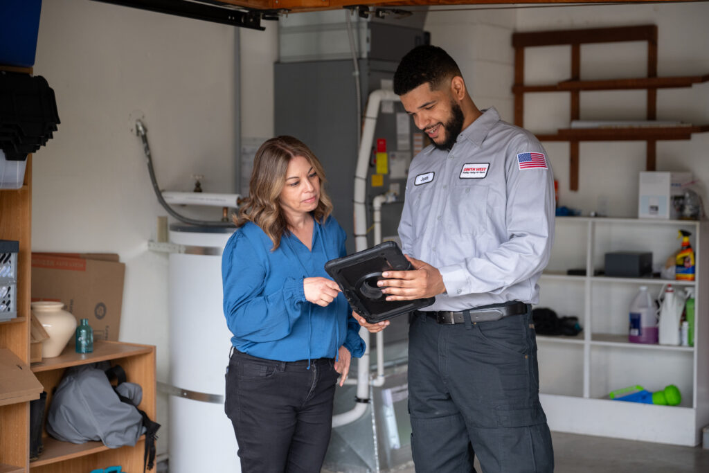 HVAC tech in Seattle working with customer to repair broken furnace.