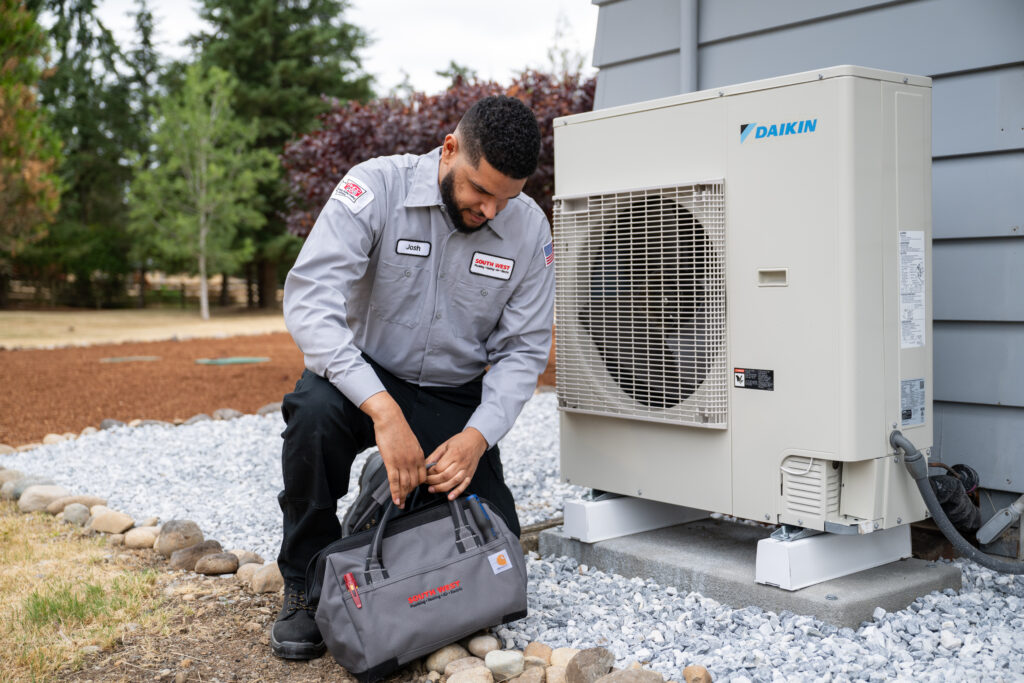 HVAC tech working on Air Conditioner.